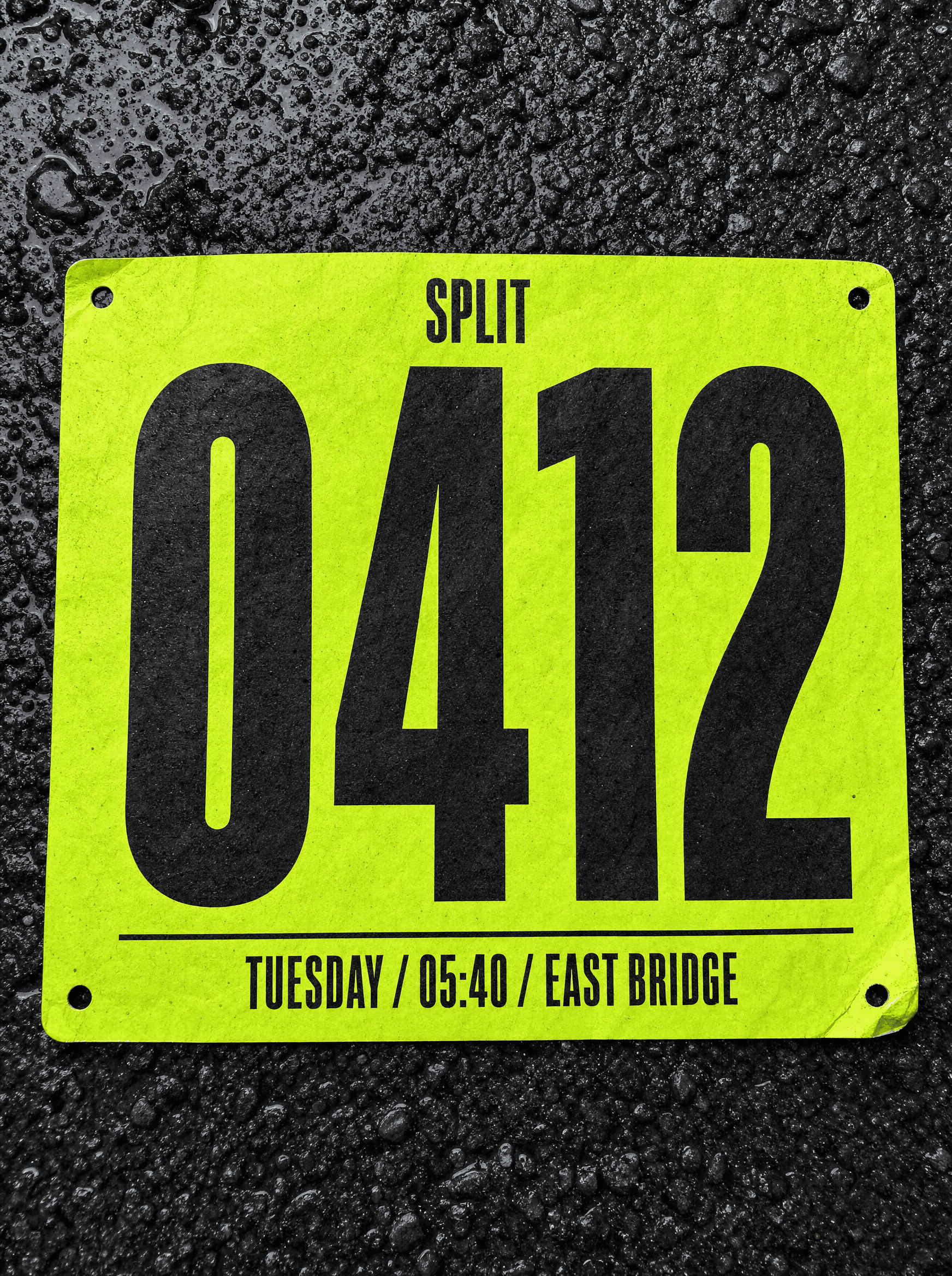 Split race bib on wet asphalt