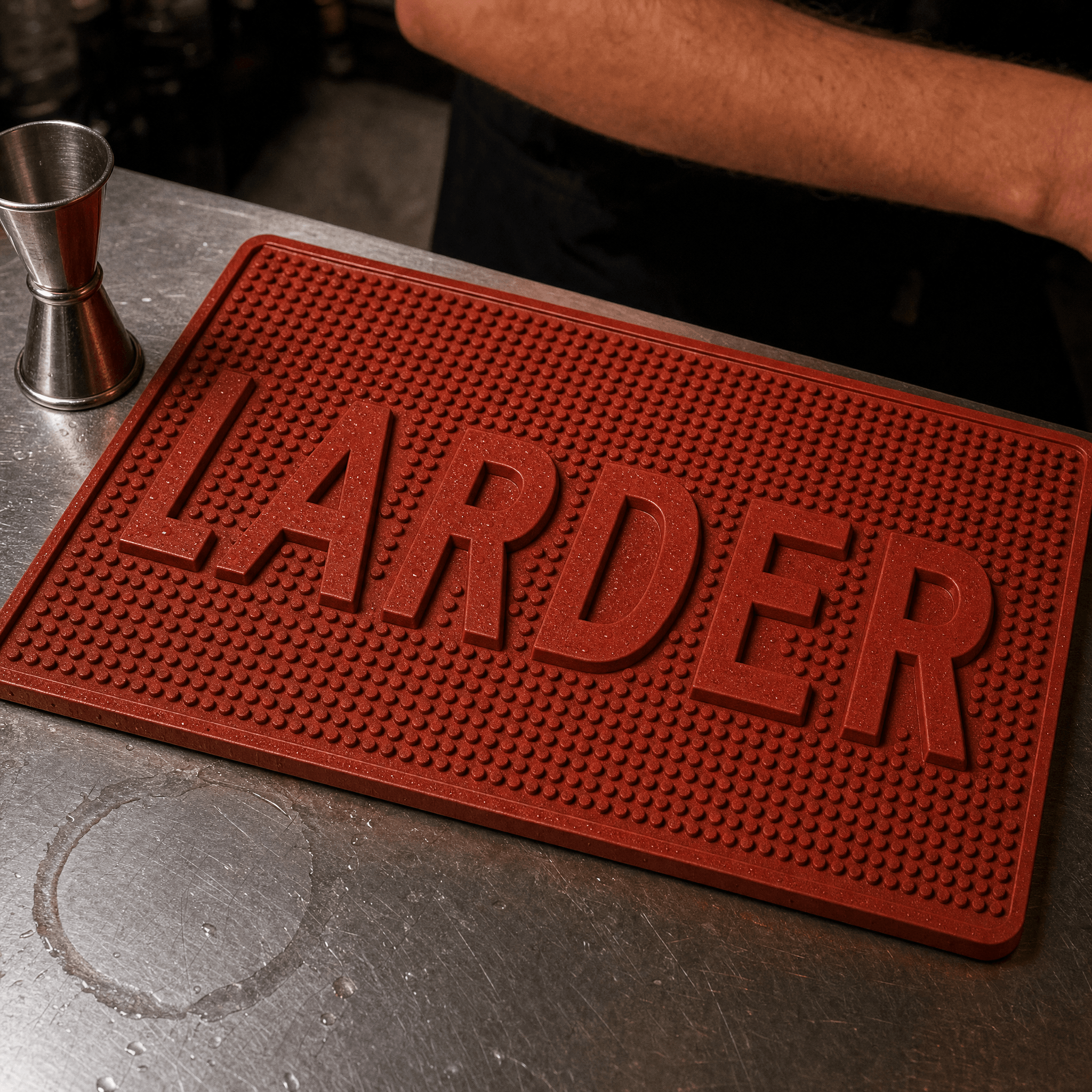 Larder bar mat in vinegar red rubber, wordmark moulded as raised relief