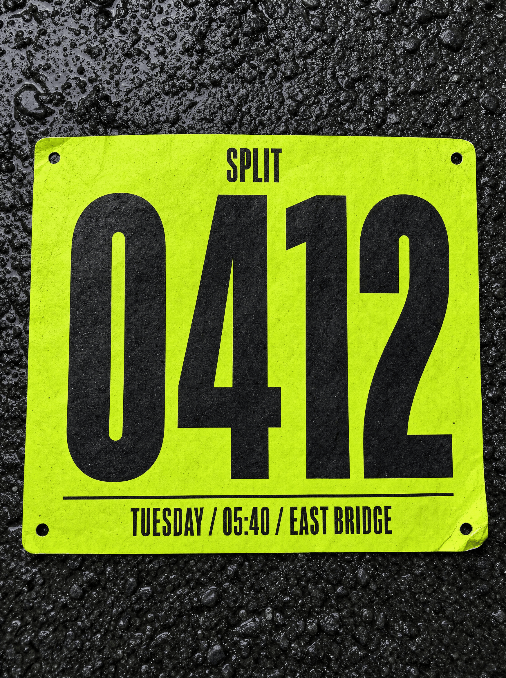 Split race bib on wet asphalt