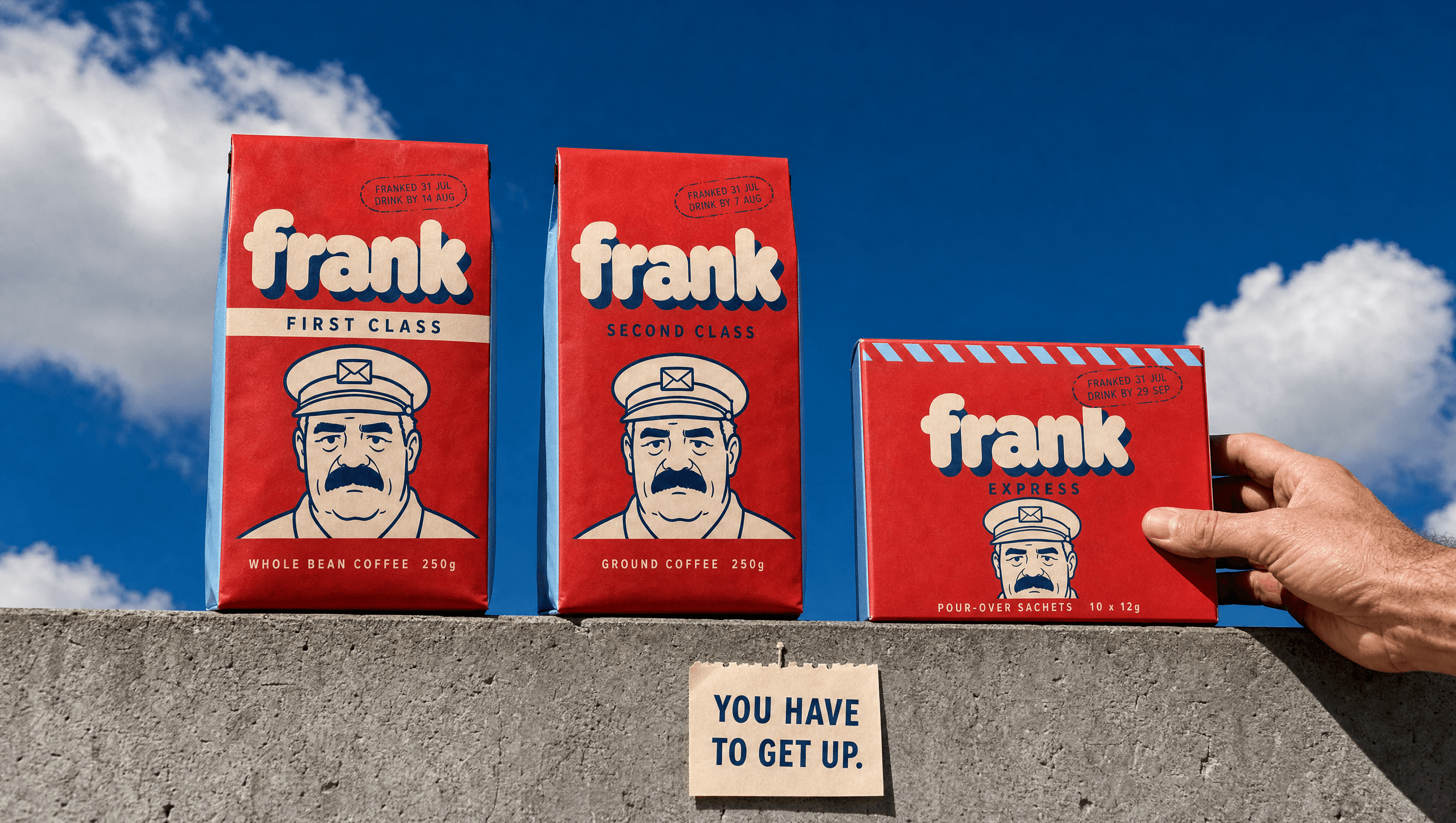 Two tall FRANK coffee bags and a shorter Express carton on a concrete ledge in hard sun, the clerk filling the lower half of each pack